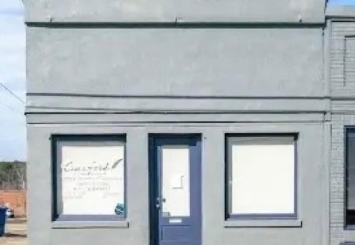 Judge Glover’s Hideout before restoration, with a painted storefront and covered windows